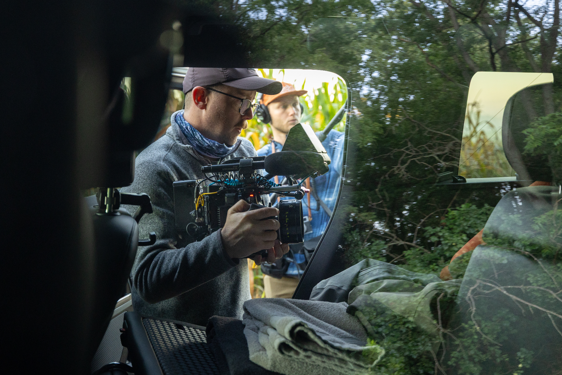 Cinematographer filming from inside a vehicle