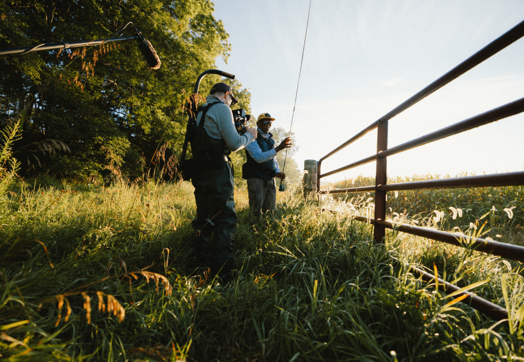 Camera and sound crew with Al at a roadside fence