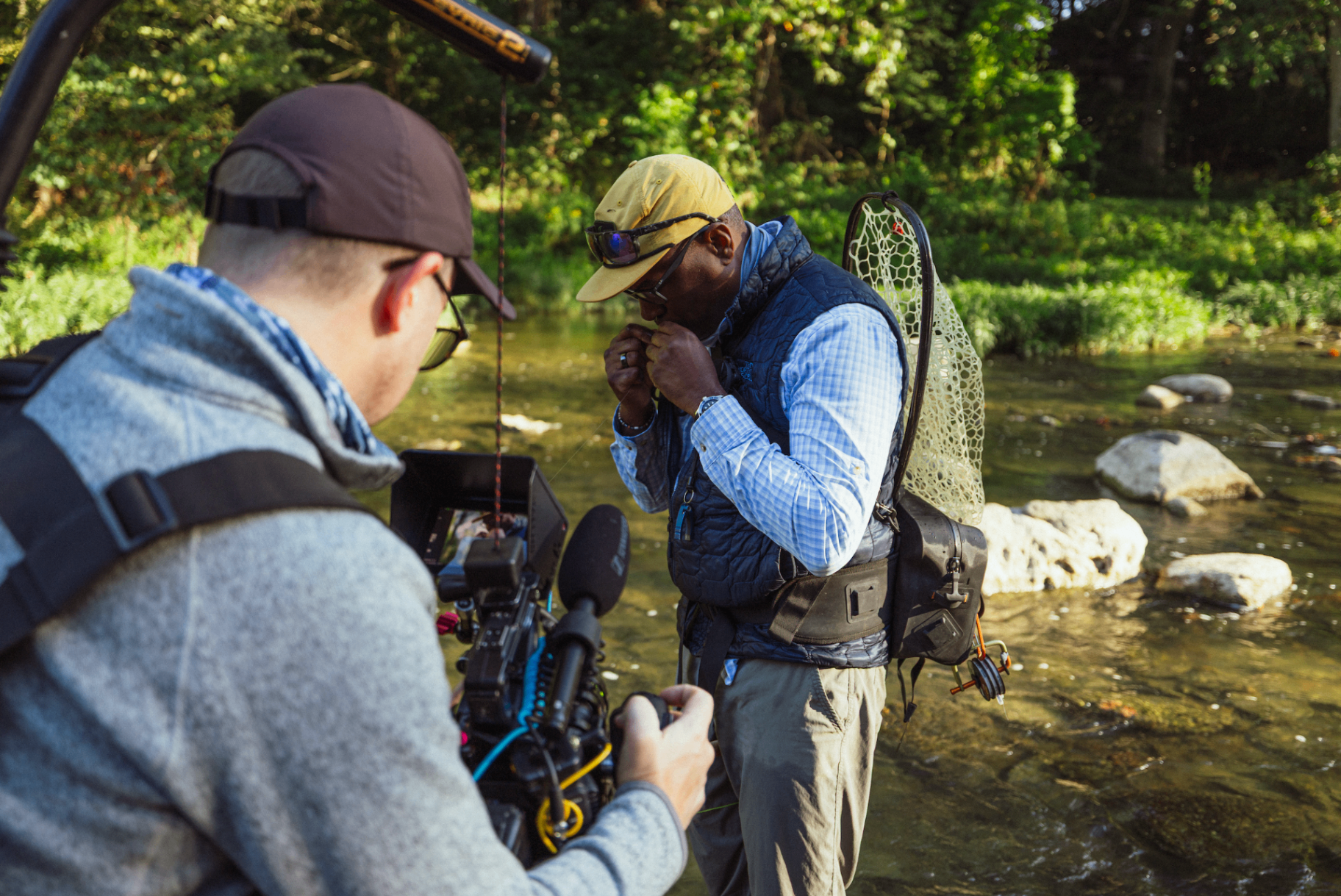Director filming Al tying a fly at the stream